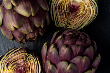 fresh artichokes close-up on dark gray background