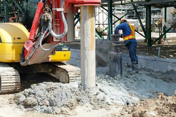 Hydraulic drilling machine is boring holes in the construction site for bored piles work. Bored piles are reinforced concrete elements cast into drilled holes, also known as replacement piles.