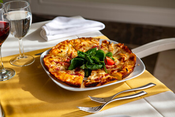 Delicious pizza served on white table.