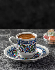 Turkish Coffee with traditional porcelain cup. Coffee presentation with Turkish delight. Sparkling Turkish Coffee..