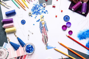 Fashion designer workplace with sketches on light background