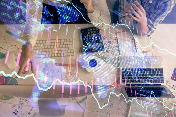 Double exposure of man and woman working together and financial chart hologram drawing. market analysis concept. Computer background. Top View.