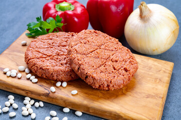 Tasty uncooked burger made with vegetarian plant based imitation minced meat ready for grill