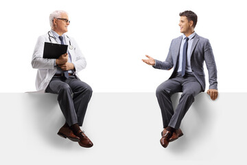 Professional man sitting on a panel and talking to a mature doctor