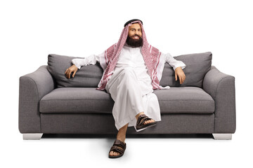 Saudi arab man resting on a gray sofa