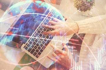 Double exposure of woman hands working on computer and forex chart hologram drawing. Top View. Financial analysis concept.