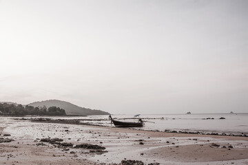 small fishing boat on the beach in the evening