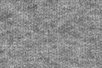 Fototapeta na wymiar Gray natural texture of knitted wool textile material background. grey crochet cotton fabric woven canvas texture. close up