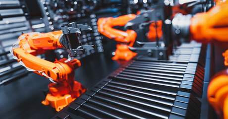 Robotic arms along assembly line in modern factory.