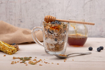 Energy granola with honey on a wooden background.