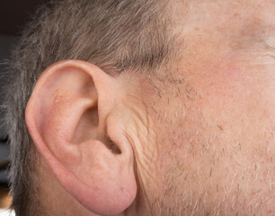Caucasian old man ear with hair