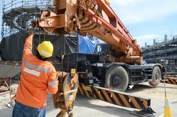 Crane operator conducting safety inspecting on the wire sling which attached with crane lifting...
