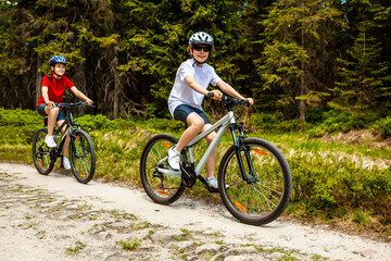 Healthy lifestyle - teenage girl and boy riding bicycles
