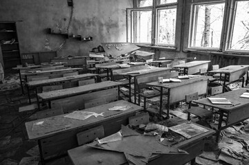 old abandoned classroom in lost school with broken windows and rusty desks and rotten books 