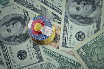 golden shining bitcoins with flag of colorado state on a dollar money background.