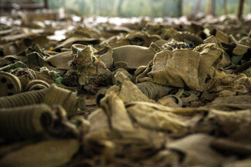 close picture of a hundreds of rotten soviet union gas mask used in liquidation of aftermath of nuclear catastrophe 