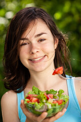 Girl eating fresh vegetable salad
