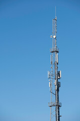 Top of a transmission tower for radio and television at blue sky