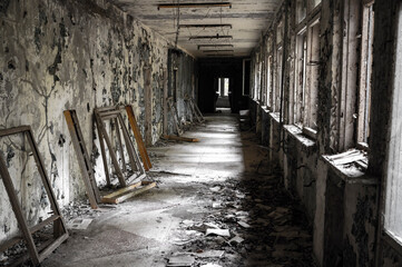old abandoned school corridor after nuclear catastrophe with rotten walls