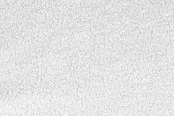 White natural texture of knitted wool textile material background. White crochet cotton fabric woven canvas texture. close up