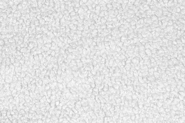 White natural texture of knitted wool textile material background. White crochet cotton fabric woven canvas texture. close up