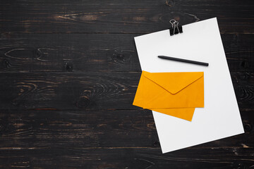 Papers with pen and envelopes on wooden background