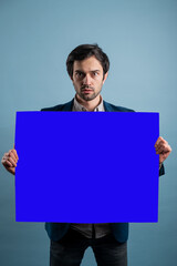 Surprised man holding blue advertising banner
