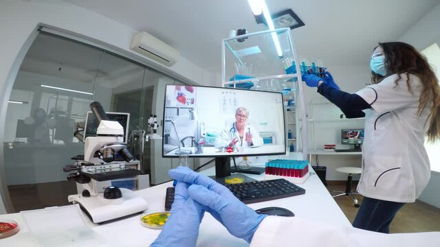 POV of scientist listening professional doctor on video call, discussing during virtual meeting in medical research lab. Chemist examining vaccine evolution using high tech researching treatment