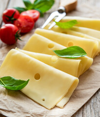 Sliced cheese, basil and tomatoes