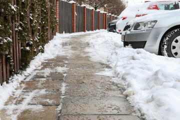 The pavement sprinkled with salt to remove snow.