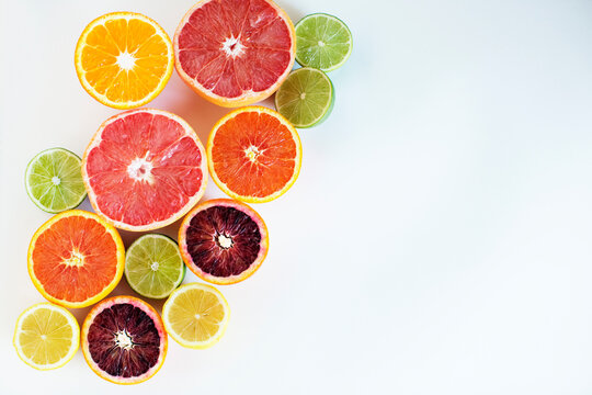 Overhead view of various chopped citrus fruits on paper