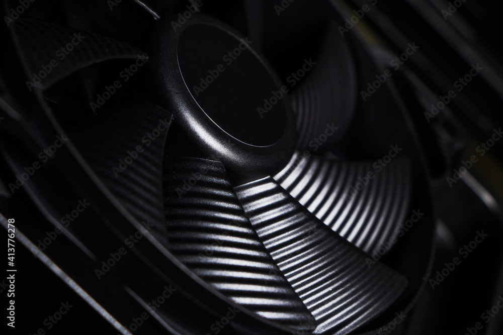 Poster cose up of computer fan on a dark background