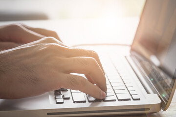 Close up of man hand using laptop computer