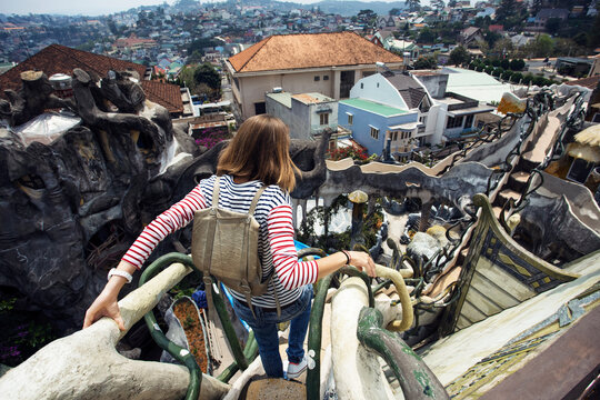 Rear view of woman moving down steps over cityscape