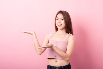 Portrait of beautiful asia young woman on Pink color background with copy space. Human face expressions, emotions feelings, body language,beauty and fashion concept.