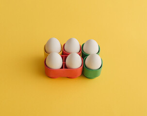 Easter eggs sorted into cubes on a yellow background.. .Holiday concept. Minimal photography style.