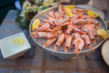 shrimp in ice with lemon on a table in a restaurant