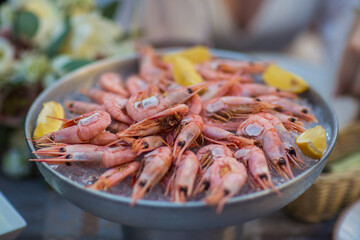 shrimp in ice with lemon on a table in a restaurant