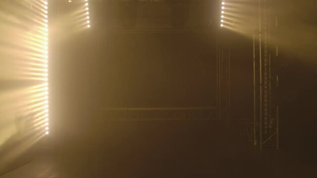 Stage with spot lighting, shining empty scene for holiday show, award ceremony or advertising. Neon lighting effects before the concert. Spotlights shine brightly, turn on and off.