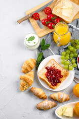 Delicious fresh breakfast served with drinks, croissants and fruits.