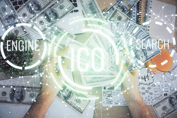 Multi exposure of blockchain theme drawing hologram and USA dollars bills and man hands. Business concept.