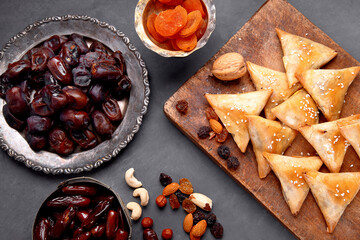 Fototapeta premium The meal eaten by Muslims after sunset during Ramadan on gray background.
