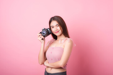 Fototapeta premium Asian woman tourist was running her to various places.happy excited emotional young woman photographer tourist standing isolated on ping background