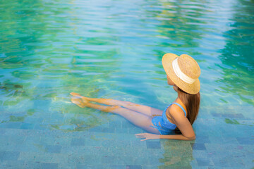 Portrait beautiful young asian woman relax smile enjoy leisure around swimming pool