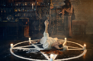 Exorcist casting out satan from creepy woman