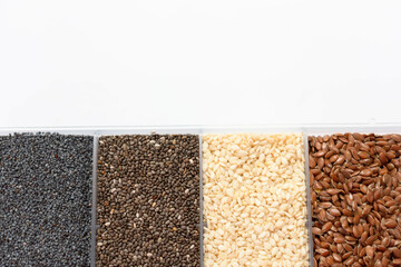 Chia, flax, sesame and poppy seeds isolated on white background.Copy space.