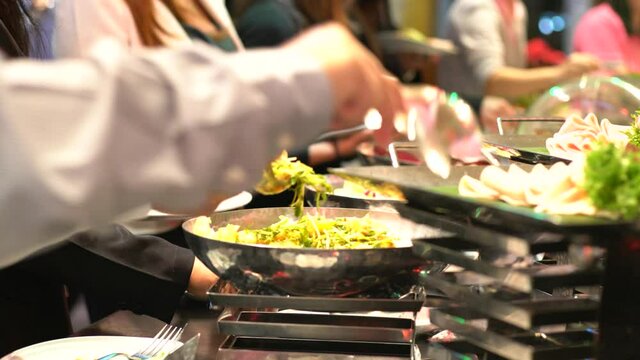 Hand of people group in catering buffet food indoor luxury hotel restaurant with meat colorful fruits and vegetables, Food Buffet Catering Dining Eating Party