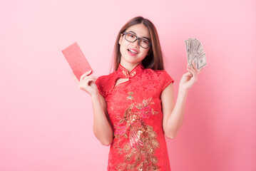 Action portrait beautiful Asian girl wearing Cheongsam red dress the celebration of something in a joyful and exuberant way. Festivities Chinese new year and Celebration concept