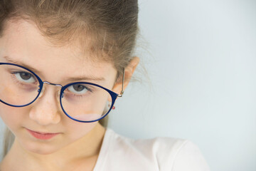 portrait of a cute and beautiful 8 year old girl with glasses