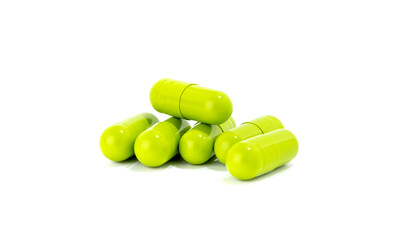 Green medicine capsules isolated on white background